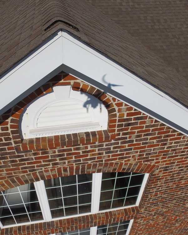 shadow of a drone inspecting a roof